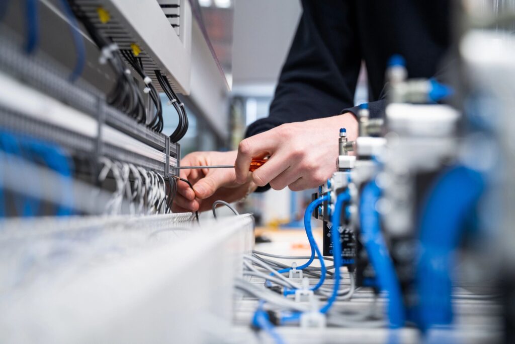 Electrician wiring an industrial control panel