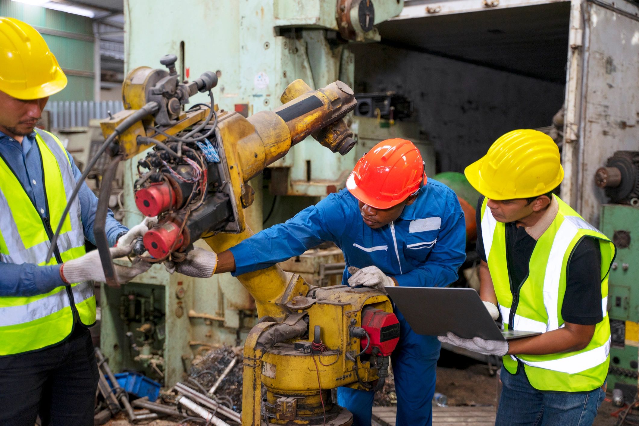 Blue collar worker work at machinery factory.