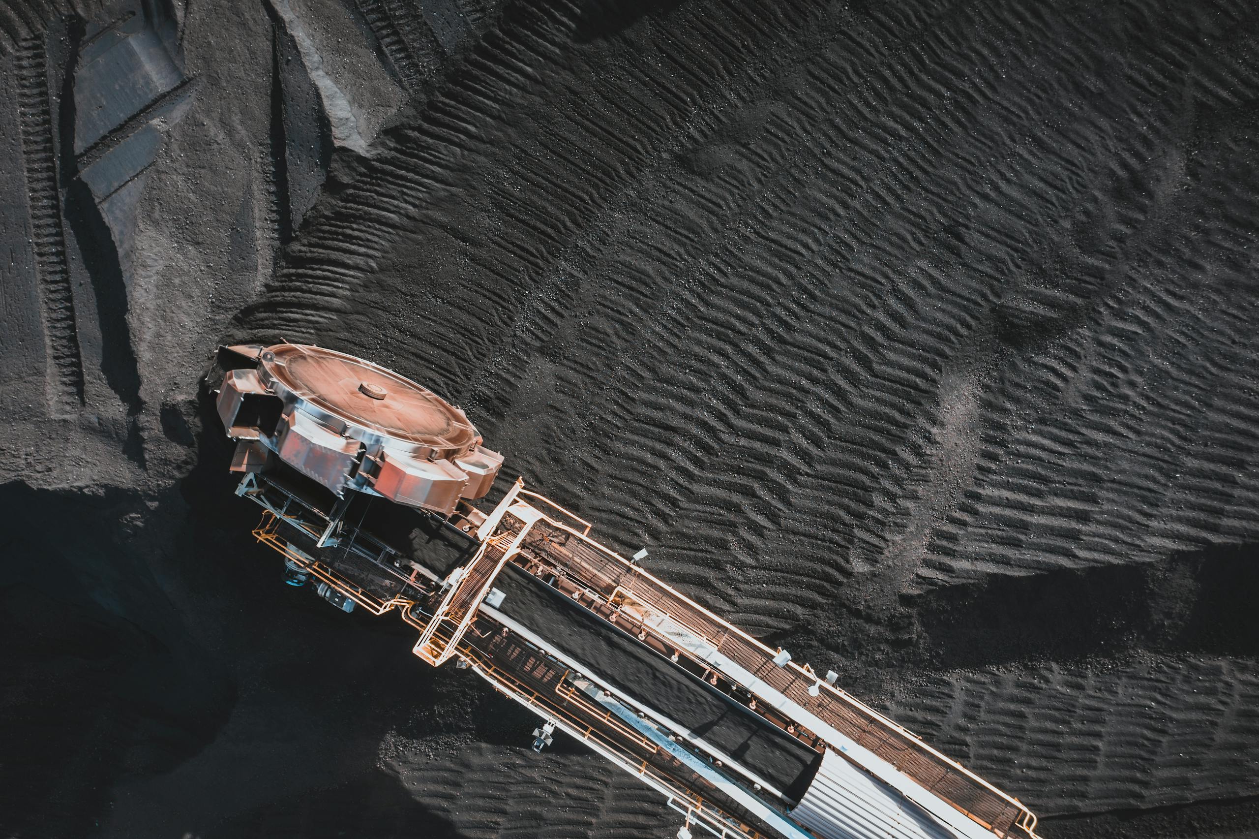 Aerial view of an industrial conveyor system at a coal mining site, showcasing engineering and machinery.